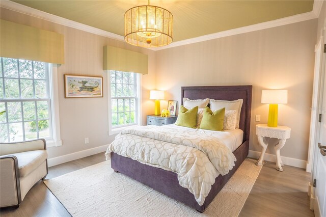 1541 Bay Point Dr, Sarasota, FL 34236 - bedroom with crown molding, baseboards, a chandelier, and wood finished floors