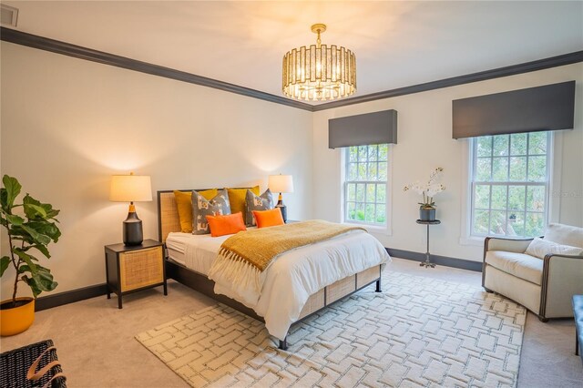 1541 Bay Point Dr, Sarasota, FL 34236 - bedroom featuring light colored carpet, crown molding, a chandelier, and baseboards