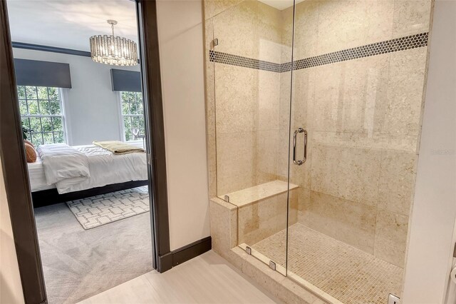 1541 Bay Point Dr, Sarasota, FL 34236 - full bathroom with connected bathroom, a shower stall, a chandelier, and baseboards