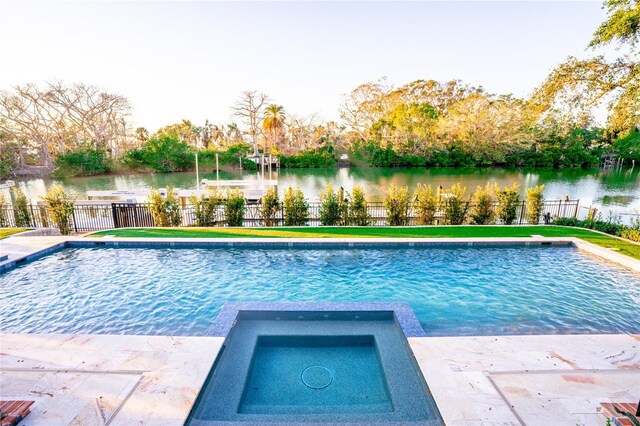1541 Bay Point Dr, Sarasota, FL 34236 - view of swimming pool with a water view, fence, and a pool with connected hot tub