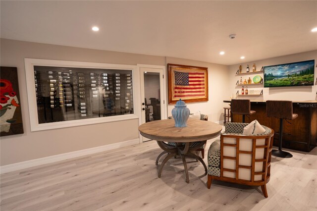 1541 Bay Point Dr, Sarasota, FL 34236 - dining room with light wood-type flooring, a bar, baseboards, and recessed lighting