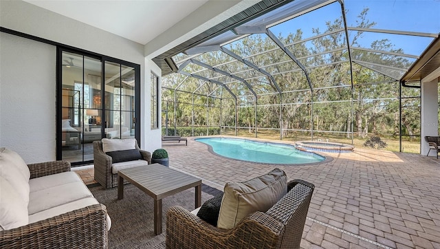 view of swimming pool with an in ground hot tub, glass enclosure, outdoor lounge area, and a patio area