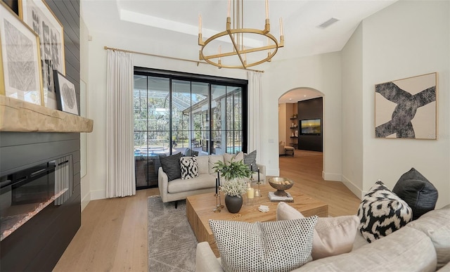 living room with hardwood / wood-style floors and an inviting chandelier