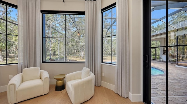 sitting room featuring a pool and light wood-type flooring