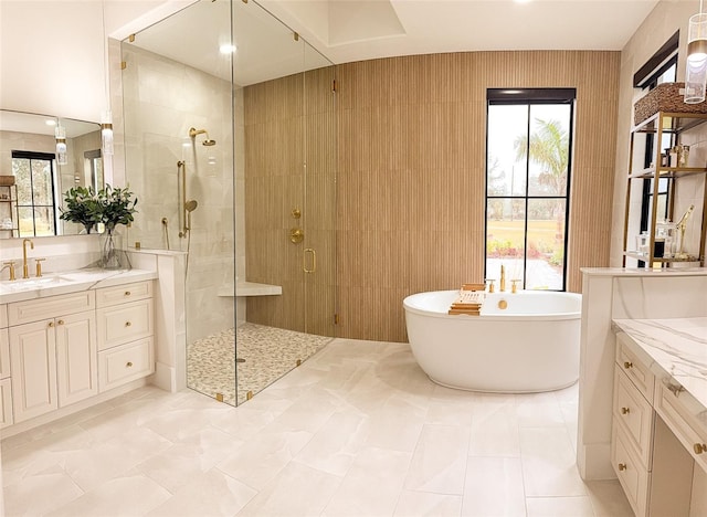 bathroom with vanity and separate shower and tub