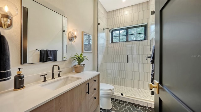 bathroom with vanity, toilet, an enclosed shower, and tile patterned flooring