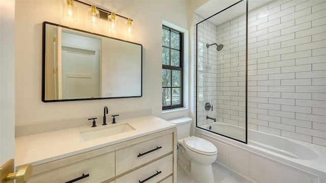 full bathroom with toilet, tiled shower / bath, and vanity