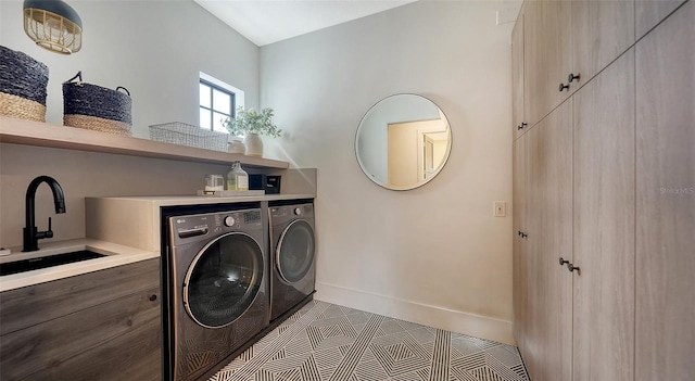 clothes washing area featuring sink, independent washer and dryer, and tile patterned flooring