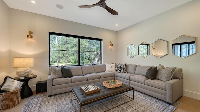 living room featuring ceiling fan and light hardwood / wood-style flooring