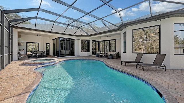 view of pool with an in ground hot tub, a patio, glass enclosure, outdoor lounge area, and ceiling fan