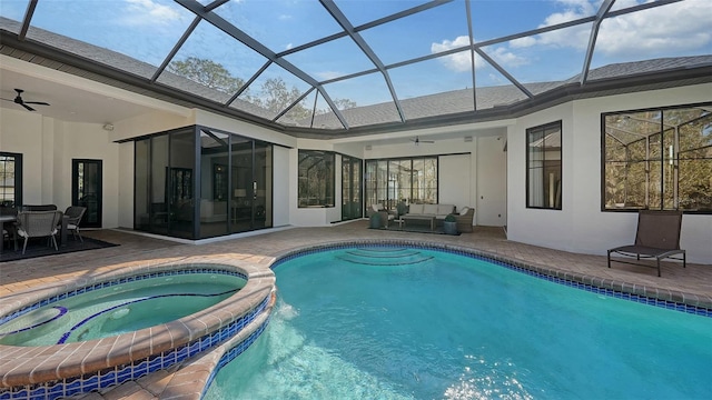 view of pool featuring an outdoor living space, an in ground hot tub, glass enclosure, ceiling fan, and a patio area