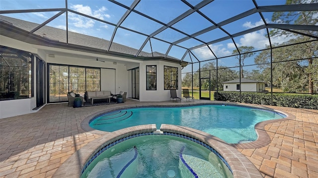 view of pool with glass enclosure, an in ground hot tub, a patio area, and an outdoor living space