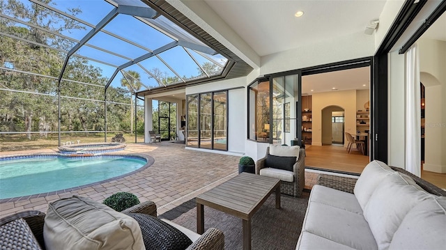 view of pool with an in ground hot tub, a lanai, an outdoor living space, and a patio area