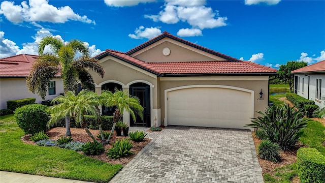 mediterranean / spanish-style house with a garage