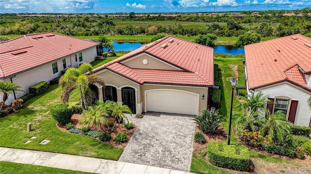 view of front facade featuring a water view and a garage