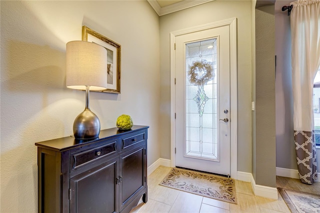 entrance foyer featuring light tile patterned flooring and crown molding