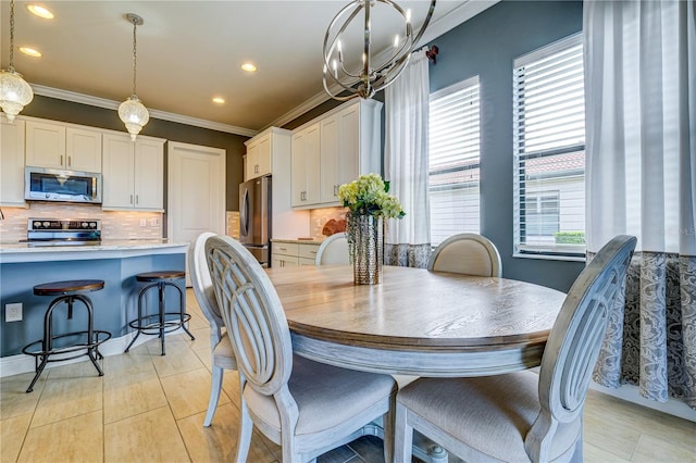 tiled dining space featuring ornamental molding and a chandelier