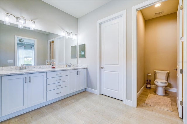 bathroom with toilet and vanity