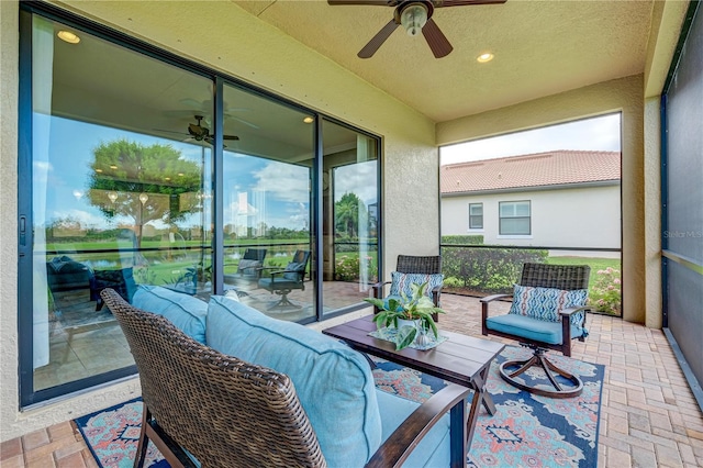 sunroom / solarium featuring ceiling fan