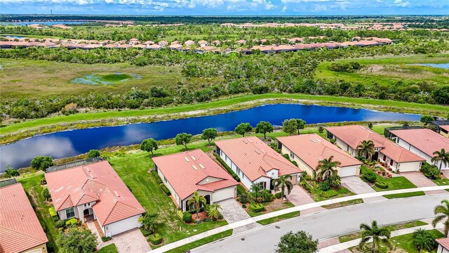 birds eye view of property with a water view