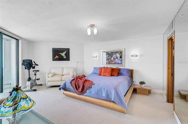 carpeted bedroom with a textured ceiling