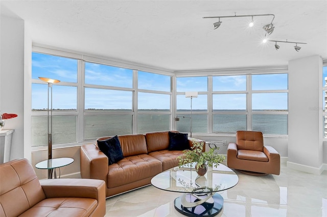 living room featuring a water view and light tile patterned floors