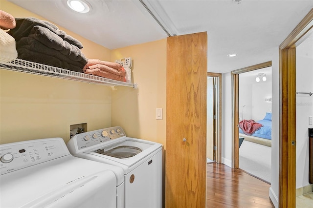 laundry room featuring light wood-type flooring and washing machine and clothes dryer