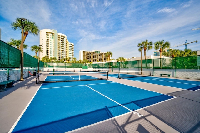 view of tennis court with basketball hoop