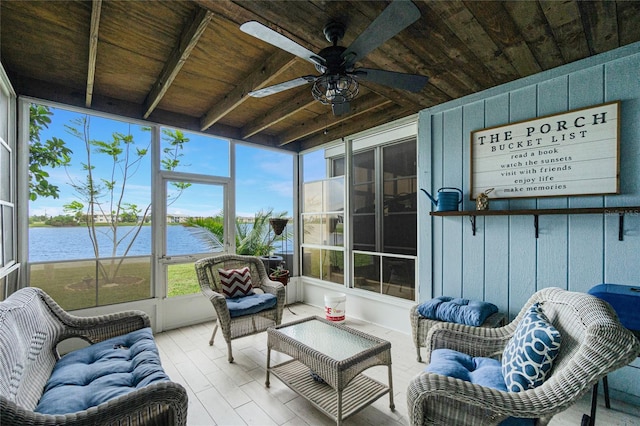 sunroom featuring beamed ceiling, ceiling fan, a water view, and wooden ceiling