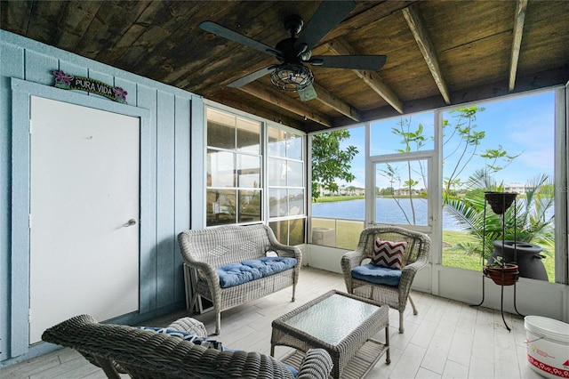 sunroom featuring beam ceiling, ceiling fan, a water view, and wood ceiling