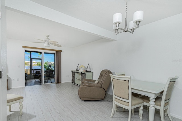 dining space with ceiling fan with notable chandelier, beam ceiling, and light hardwood / wood-style flooring