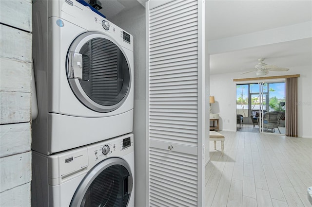 laundry room featuring ceiling fan and stacked washer and clothes dryer