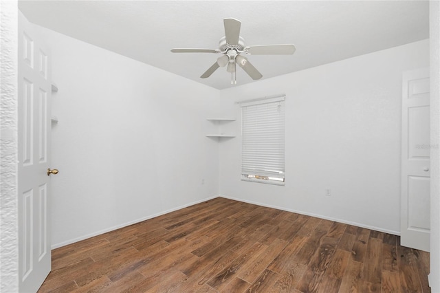 empty room with ceiling fan and dark wood-type flooring