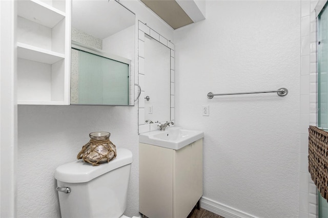 bathroom with vanity, toilet, and an enclosed shower