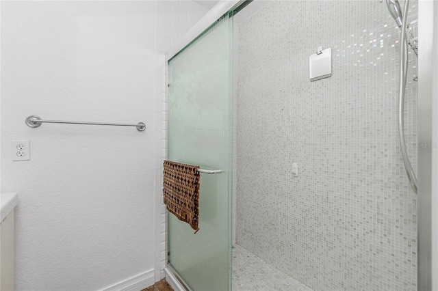 bathroom with a shower with shower door