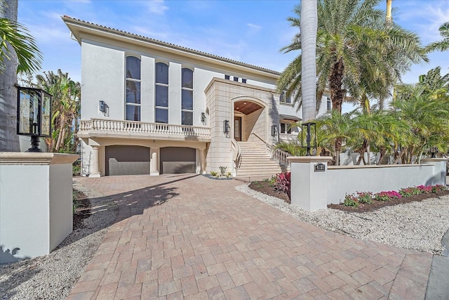 view of front facade with a balcony and a garage