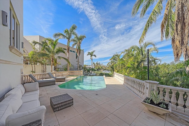 view of swimming pool with a patio area and an outdoor living space