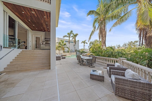 view of patio with a fenced in pool, area for grilling, and an outdoor living space