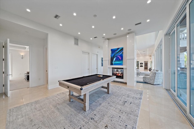 game room featuring pool table, a multi sided fireplace, and light tile patterned floors