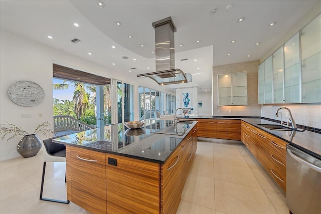 kitchen with a large island, dishwasher, decorative backsplash, sink, and light tile patterned flooring