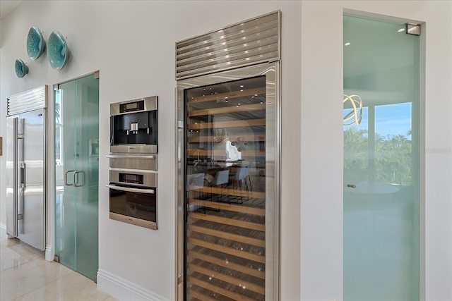 wine cellar featuring light tile patterned floors and wine cooler