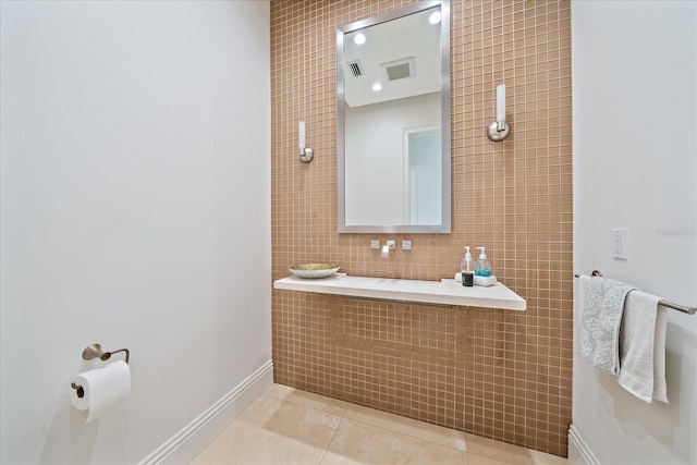 bathroom featuring tile patterned flooring and tile walls