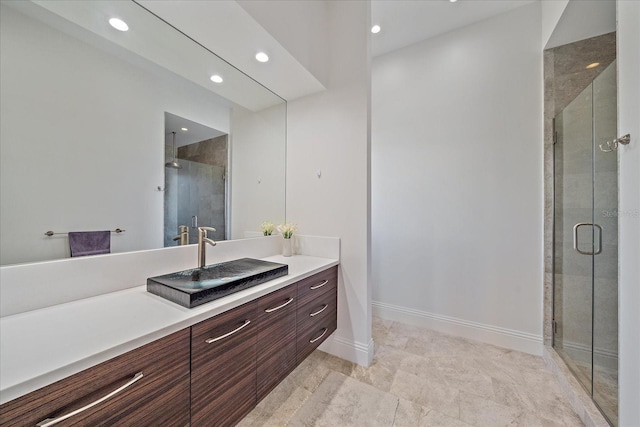 bathroom featuring an enclosed shower and vanity