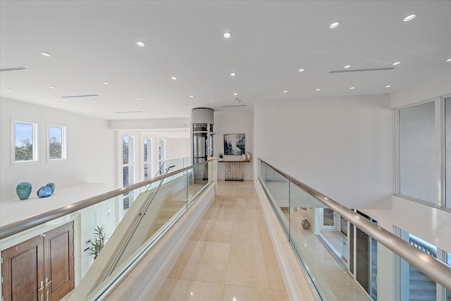 hall featuring light tile patterned floors