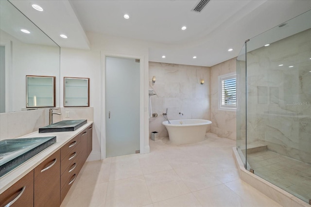 bathroom with tile patterned floors, plus walk in shower, and vanity