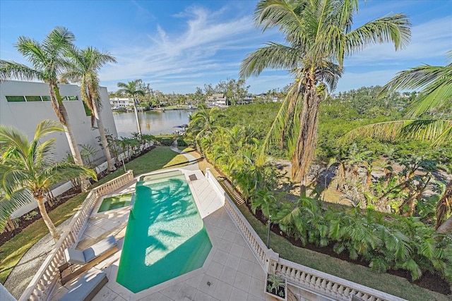 view of swimming pool featuring a water view and a patio area