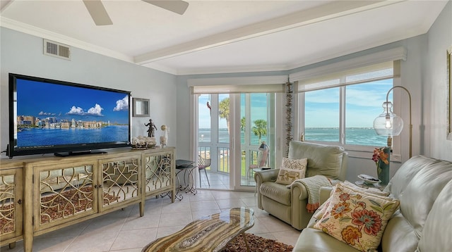 tiled living room with ceiling fan, crown molding, and a water view