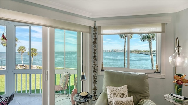 doorway to outside featuring light tile patterned flooring, a water view, and ornamental molding