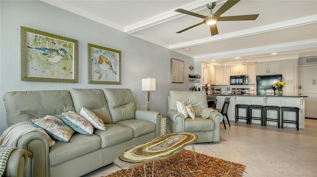 living room featuring ceiling fan, light tile patterned flooring, and ornamental molding