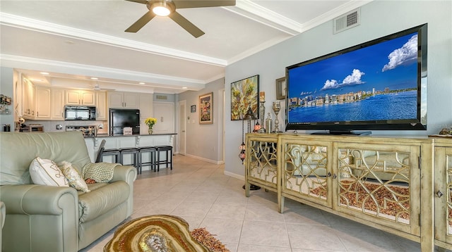 living room with light tile patterned floors, ceiling fan, ornamental molding, and beam ceiling